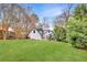 Beautifully maintained backyard with green lawn and partial view of the home's exterior and pergola at 1466 University Dr, Atlanta, GA 30306