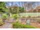 A stone retaining wall separates the yard, creating a picturesque garden path at 1466 University Dr, Atlanta, GA 30306