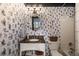 A renovated bathroom has unique wallpaper, granite counters, and a shower/tub combo at 1466 University Dr, Atlanta, GA 30306