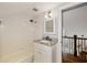 Clean bathroom featuring a shower-tub combo, and modern fixtures, plus a staircase at 1466 University Dr, Atlanta, GA 30306