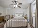 Cozy bedroom with a decorative ceiling fan and large, plush bed with reading lamps at 1466 University Dr, Atlanta, GA 30306