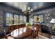 Elegant dining room with beautiful wallpaper, a large window, and a chandelier perfect for hosting dinners at 1466 University Dr, Atlanta, GA 30306