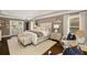 Bright and airy primary bedroom suite with hardwood floors, a seating area, and double doors to the patio at 1466 University Dr, Atlanta, GA 30306