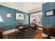 Office with unique blue walls, a desk with a leather chair, and a window showing the flag outside at 1466 University Dr, Atlanta, GA 30306