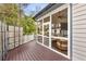 This screened-in porch has wicker furniture and views of the backyard at 1466 University Dr, Atlanta, GA 30306