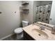 Bathroom featuring a toilet and a vanity with a sink, offering essential amenities in a functional layout at 5609 Windwood Rd, Atlanta, GA 30349