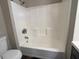 Clean bathroom featuring a shower and tub combination with white tile surround at 5609 Windwood Rd, Atlanta, GA 30349