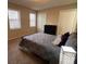 Bedroom with two windows, carpet, and ample closet space at 5609 Windwood Rd, Atlanta, GA 30349