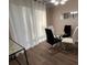Dining area featuring modern light fixture, a glass table, and neutral tones at 5609 Windwood Rd, Atlanta, GA 30349