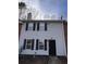 Traditional two-story townhouse with white siding, black shutters, and a brick accent at 5609 Windwood Rd, Atlanta, GA 30349
