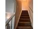 Carpeted stairway with white trim and neutral wall color at 5609 Windwood Rd, Atlanta, GA 30349