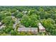 Aerial view of a multi-story brick building with manicured landscaping nestled among lush green trees and foliage at 795 Ponce De Leon Ne Pl # C3, Atlanta, GA 30306