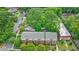 Aerial view of a multi-story brick building with manicured landscaping nestled among lush green trees and foliage at 795 Ponce De Leon Ne Pl # C3, Atlanta, GA 30306
