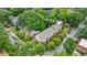 Aerial view of a multi-story brick building with manicured landscaping nestled among lush green trees and foliage at 795 Ponce De Leon Ne Pl # C3, Atlanta, GA 30306