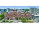Aerial view showcasing mixed-use building complex with surrounding greenery and street access at 795 Ponce De Leon Ne Pl # C3, Atlanta, GA 30306