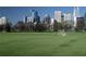 A wide-angle view of Atlanta's skyline behind a vibrant green field with a soccer goal at 795 Ponce De Leon Ne Pl # C3, Atlanta, GA 30306