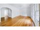 Sunlit empty room with hardwood floors, white walls, and French doors leading to balcony at 795 Ponce De Leon Ne Pl # C3, Atlanta, GA 30306