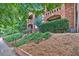 Multi-story brick building with manicured landscaping and charming balconies nestled among lush green trees and foliage at 795 Ponce De Leon Ne Pl # C3, Atlanta, GA 30306