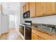 A bright kitchen features wooden cabinets, granite countertops, and appliances at 795 Ponce De Leon Ne Pl # C3, Atlanta, GA 30306