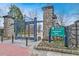 Entrance to Piedmont Park, featuring stone pillars, iron gates, and landscaped flower beds at 795 Ponce De Leon Ne Pl # C3, Atlanta, GA 30306