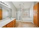 Bright bathroom featuring a large mirror, vanity with cabinets, and separate shower and tub at 2726 Pierce Brennen Ct, Lawrenceville, GA 30043