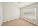 Neutral bedroom with a ceiling fan and a bright window with blinds at 2726 Pierce Brennen Ct, Lawrenceville, GA 30043