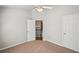 Bedroom with neutral walls and carpet plus entryways to additional rooms at 2726 Pierce Brennen Ct, Lawrenceville, GA 30043