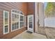 Exterior with wood siding, door, and large windows at 2726 Pierce Brennen Ct, Lawrenceville, GA 30043