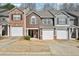 Townhome with attached one car garage, brick and wood facade at 2726 Pierce Brennen Ct, Lawrenceville, GA 30043