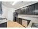 Well-lit kitchen featuring black cabinets, stainless steel appliances, and light granite countertops at 2726 Pierce Brennen Ct, Lawrenceville, GA 30043