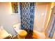 Bathroom featuring a toilet, shower, and blue patterned shower curtain at 32 Peachtree Nw St # 202, Atlanta, GA 30303