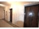 Classic elevators with wood paneled doors set within a marble wall at 32 Peachtree Nw St # 202, Atlanta, GA 30303