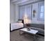 Comfortable living area with couch, bed, and stylish coffee table illuminated by natural light through sheer curtains at 32 Peachtree Nw St # 202, Atlanta, GA 30303