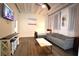 A modern living room featuring hardwood floors, a comfortable couch, and a flat-screen television for entertainment at 32 Peachtree Nw St # 202, Atlanta, GA 30303