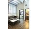Living room showing hardwood floors, sheer curtains, gray sofa and view into bathroom and vanity at 32 Peachtree Nw St # 202, Atlanta, GA 30303