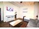 Cozy living space featuring hardwood floors, a TV, and an open kitchen area at 32 Peachtree Nw St # 202, Atlanta, GA 30303