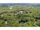 Expansive wooded acreage surrounding the home, with lush green trees and glimpses of a nearby river at 385 Grimes Bridge Rd, Roswell, GA 30075