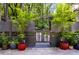 Backyard with gate, trees, and potted plants at 385 Grimes Bridge Rd, Roswell, GA 30075