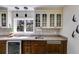 This bar features glass cabinets, a mini refrigerator, and mosaic backsplash at 385 Grimes Bridge Rd, Roswell, GA 30075