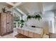 Relaxing bathroom features a large soaking tub, wood-beamed ceiling, and a window overlooking a serene wooded area at 385 Grimes Bridge Rd, Roswell, GA 30075