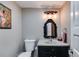 Powder room boasts a black vanity, decorative mirror, and a modern light fixture, providing style and utility at 385 Grimes Bridge Rd, Roswell, GA 30075