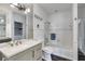 Bright bathroom featuring a combination shower-tub with tiled walls and a white vanity at 385 Grimes Bridge Rd, Roswell, GA 30075