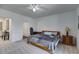 Carpeted bedroom with neutral colors, a ceiling fan, and a desk at 385 Grimes Bridge Rd, Roswell, GA 30075
