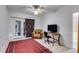 Bedroom with a door to the outside, desk, plush chair, and a vibrant red oriental rug at 385 Grimes Bridge Rd, Roswell, GA 30075