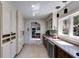 Bright butler's pantry features white cabinets, contrasting wood base cabinets, and tile floors at 385 Grimes Bridge Rd, Roswell, GA 30075