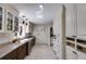 Spacious butler's pantry with white cabinets, contrasting lower wood cabinets, and beverage refrigerator at 385 Grimes Bridge Rd, Roswell, GA 30075