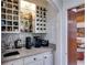 Butler's pantry featuring custom cabinets with open shelving, mosaic backsplash, and a small sink at 385 Grimes Bridge Rd, Roswell, GA 30075