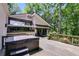 Back deck featuring a luxurious hot tub, lounge chairs, and lush greenery offering relaxation at 385 Grimes Bridge Rd, Roswell, GA 30075
