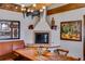 Dining area with built in seating, fireplace, and exposed wood beam ceiling at 385 Grimes Bridge Rd, Roswell, GA 30075