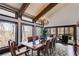 Elegant dining room with vaulted ceilings, wood beams, chandelier, and access to outdoor deck, perfect for entertaining at 385 Grimes Bridge Rd, Roswell, GA 30075